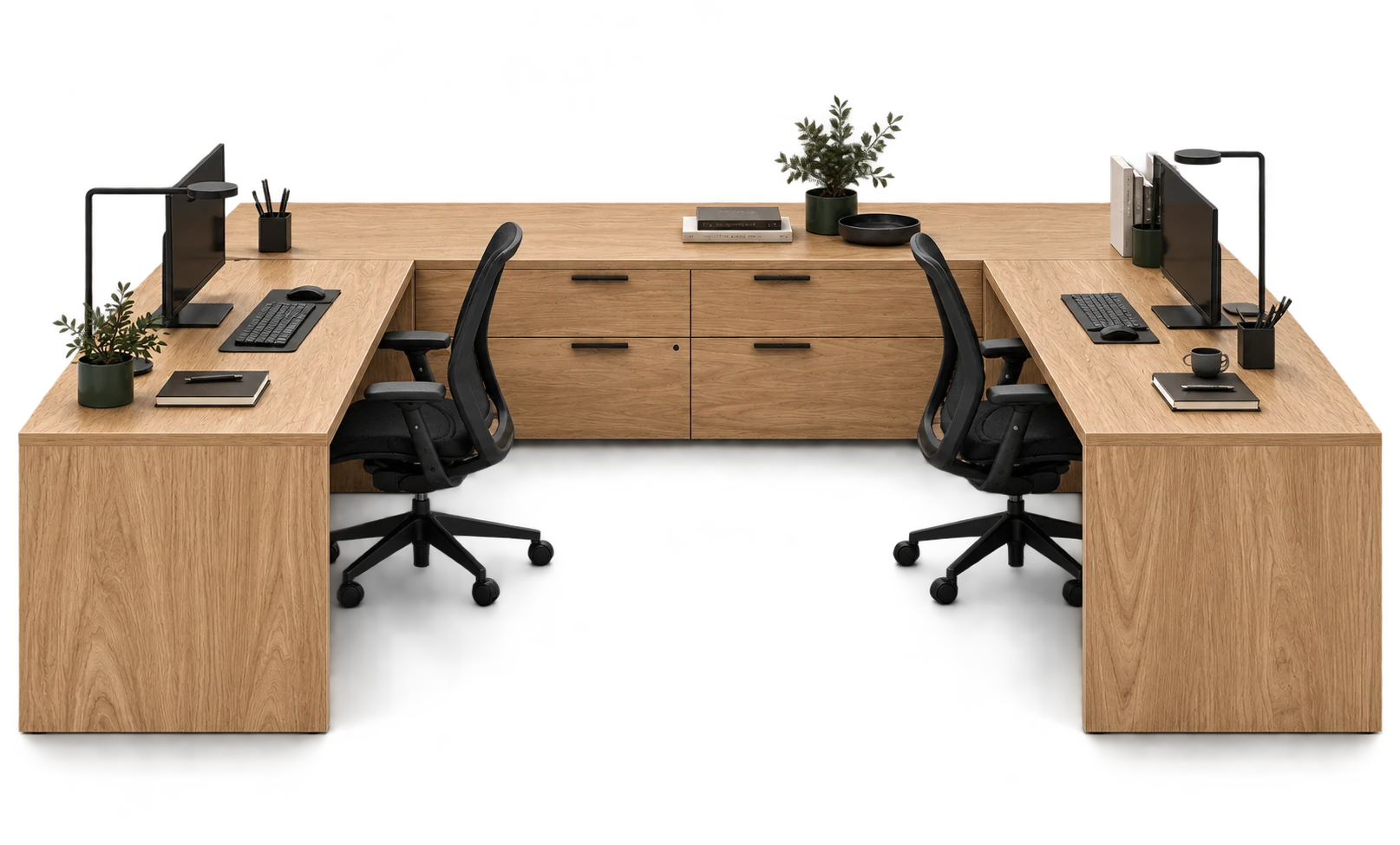 Natural oak two-person workstation with a shared drawer bank, black task chairs, monitors, and plants